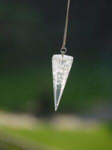 A clear glass hanging decoration in the shape of an icicle.