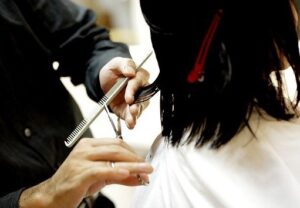 A person getting their hair cut at the salon