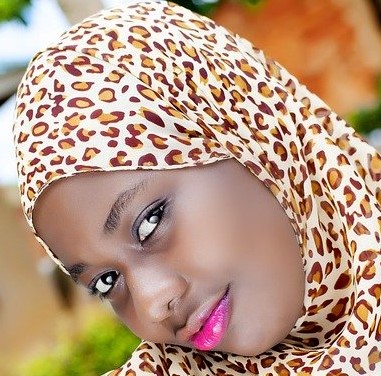 A woman with a leopard print head scarf.