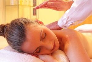 A woman getting her face and neck massage