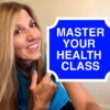 A woman holding up a sign that says master your health class.