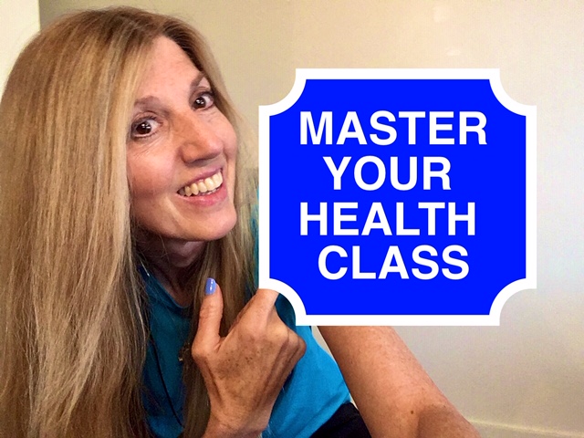 A woman holding up a sign that says master your health class.