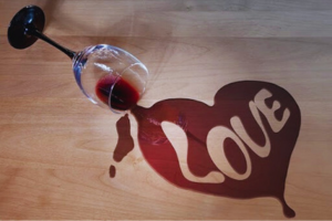 A glass of wine is spilled on the floor.