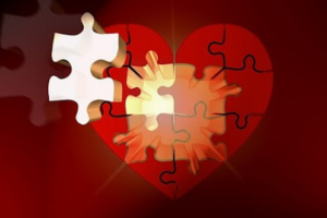 A heart shaped puzzle with pieces missing.